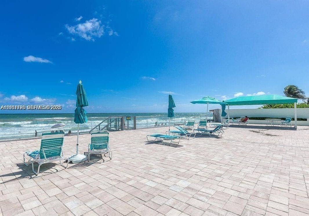 3725 S Ocean Drive, #508, Hollywood, Hollywood, FL 33019 Expansive paved terrace featuring a glass panel perimeter railing and a permanent shade structure