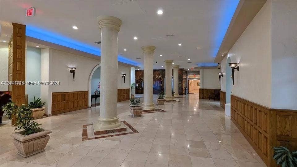 3725 S Ocean Drive, #508, Hollywood, Hollywood, FL 33019 Spacious lobby featuring polished stone flooring, structural columns, recessed lighting, cove accent lighting, and wood paneling