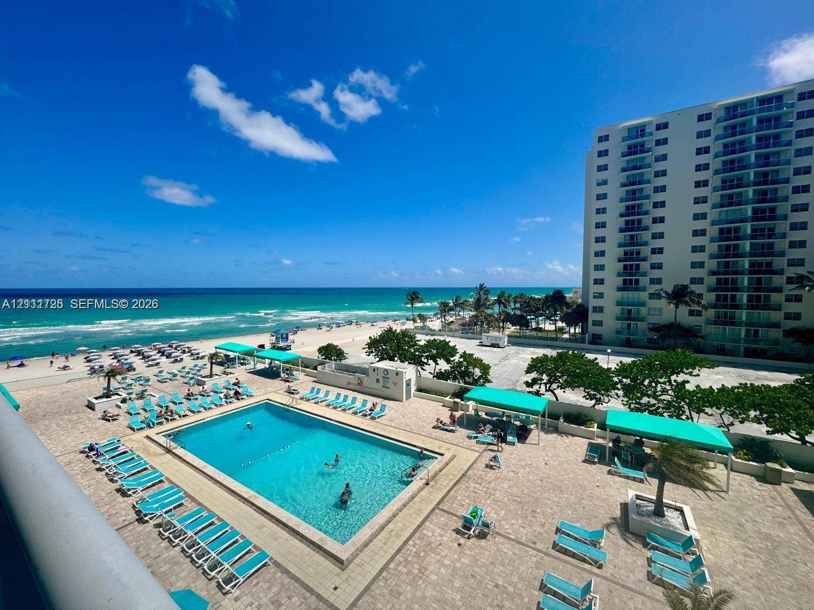 3725 S Ocean Drive, #508, Hollywood, Hollywood, FL 33019 Community swimming pool with a paved deck, turquoise water, and expansive ocean scenery