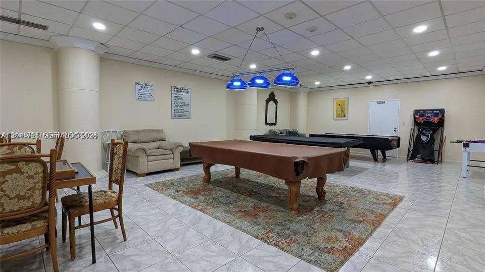 3725 S Ocean Drive, #508, Hollywood, Hollywood, FL 33019 Large recreation room featuring light-colored tile flooring, a suspended drop ceiling, recessed lighting, and a multi-pendant billiards fixture