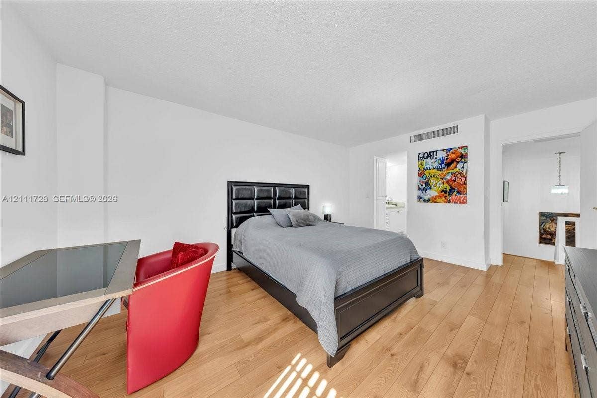Bedroom featuring wood-finish flooring, neutral walls, and a recessed ceiling light fixture