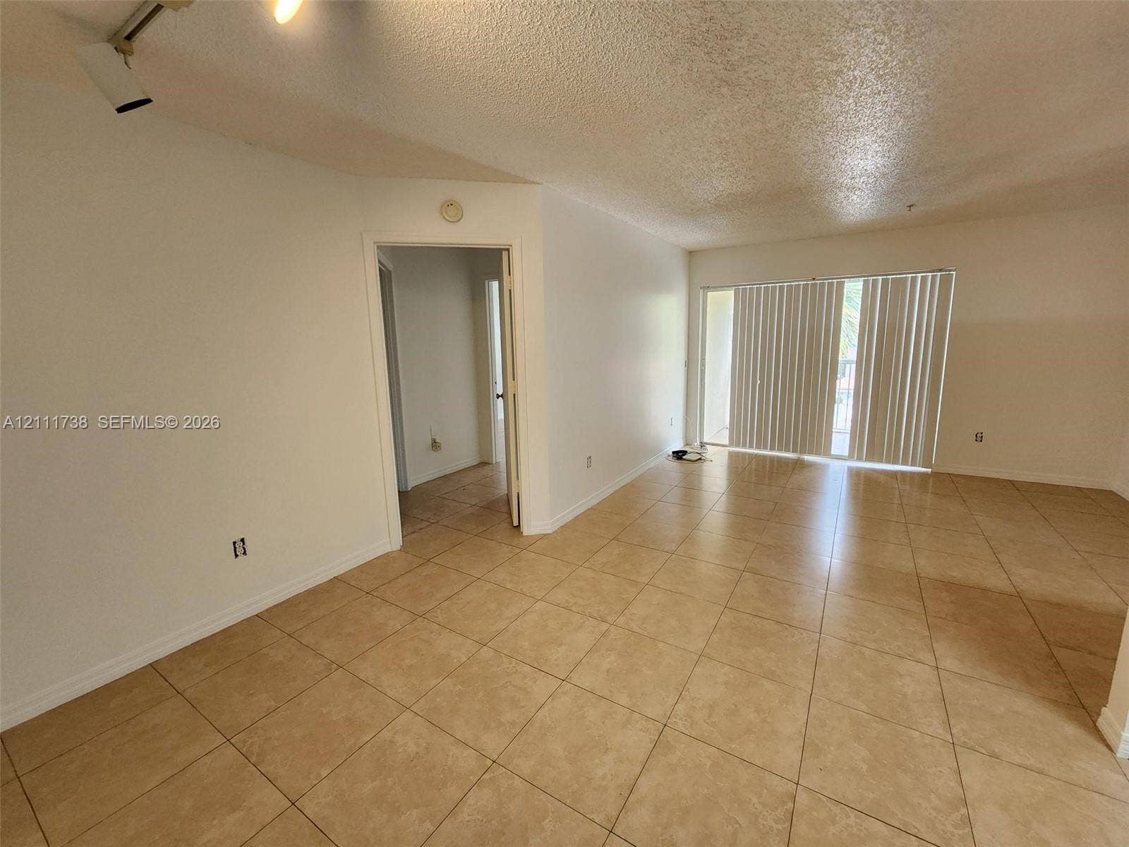 460 S Park Road, #308, Hollywood, Hollywood, FL 33021 Open-concept interior featuring oversized tile flooring, track lighting, and floor-to-ceiling sliding glass doors
