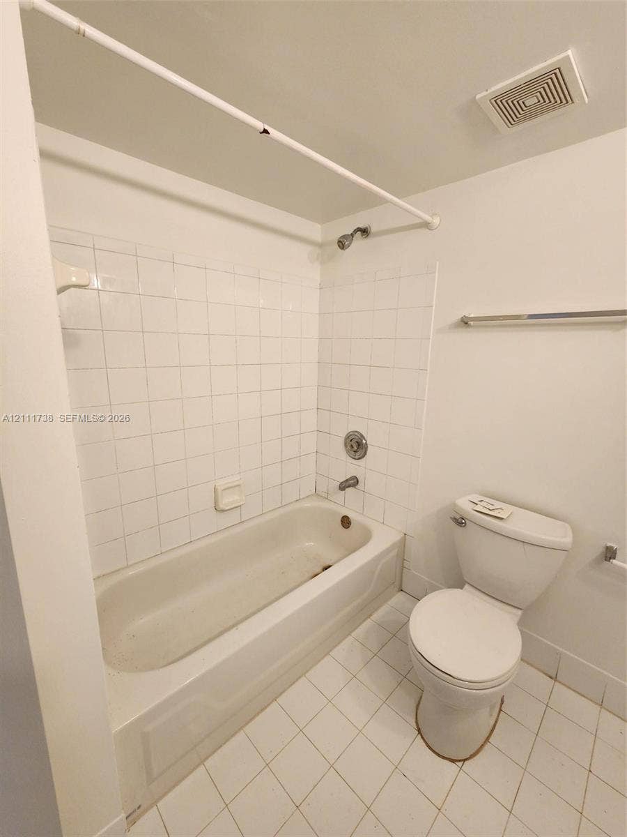 460 S Park Road, #308, Hollywood, Hollywood, FL 33021 Bathroom featuring a white porcelain tub, square wall tiling, ceramic tile flooring, and a standard-height toilet