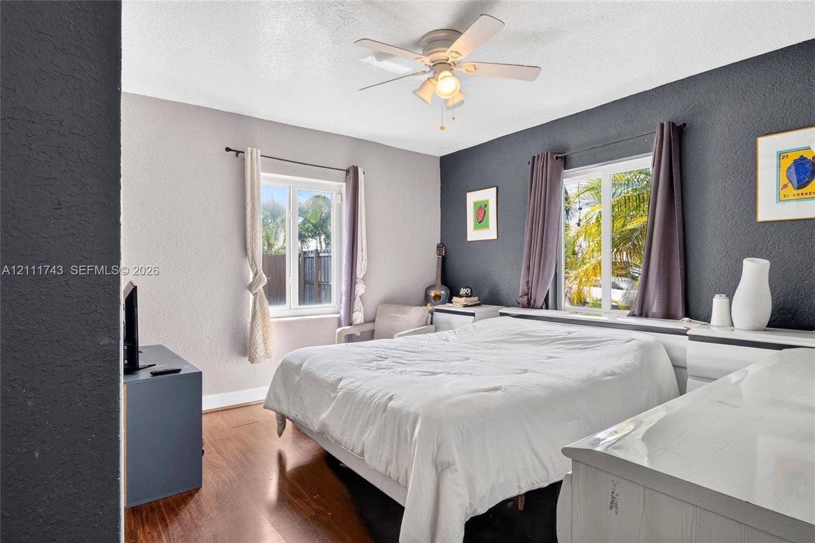 5524 N Andrews Avenue, Oakland Park, FL 33309 Wood-finish flooring, dual-tone painted walls, and ceiling-mounted light fixture with fan