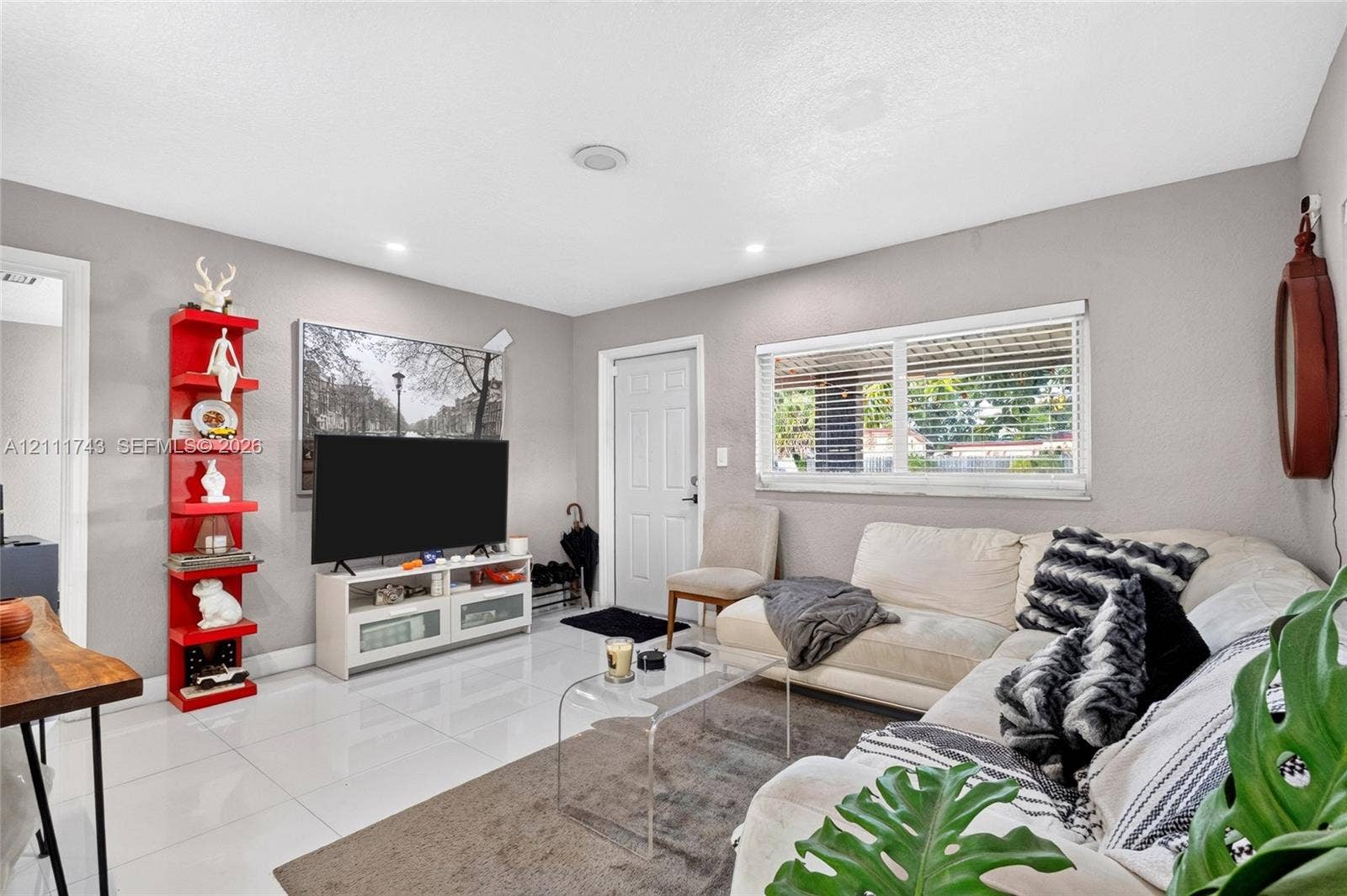 5524 N Andrews Avenue, Oakland Park, FL 33309 Polished tile flooring, recessed ceiling lighting, and horizontal window blinds