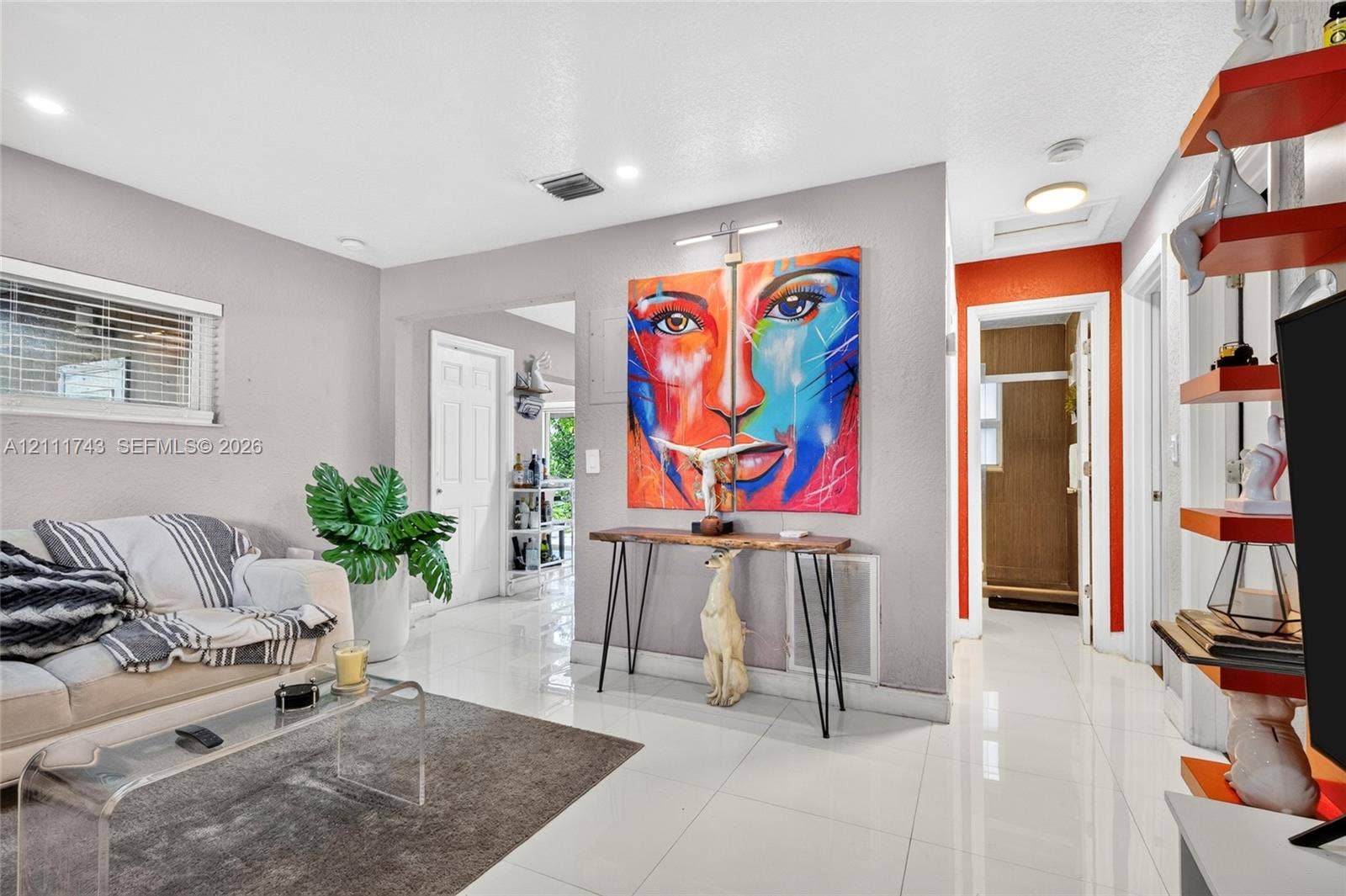 5524 N Andrews Avenue, Oakland Park, FL 33309 Neutral-toned interior featuring polished tile flooring, recessed lighting, and wall-mounted picture lighting