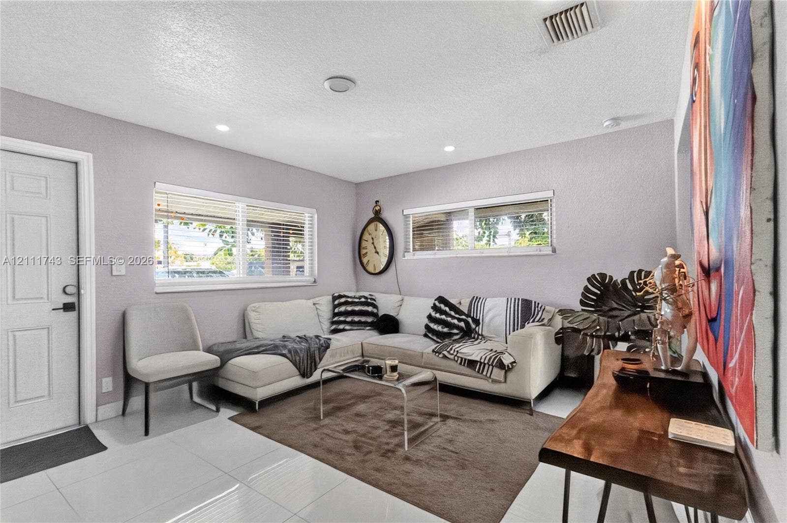 5524 N Andrews Avenue, Oakland Park, FL 33309 Bright interior featuring large-format ceramic tile flooring, recessed lighting, and horizontal window blinds