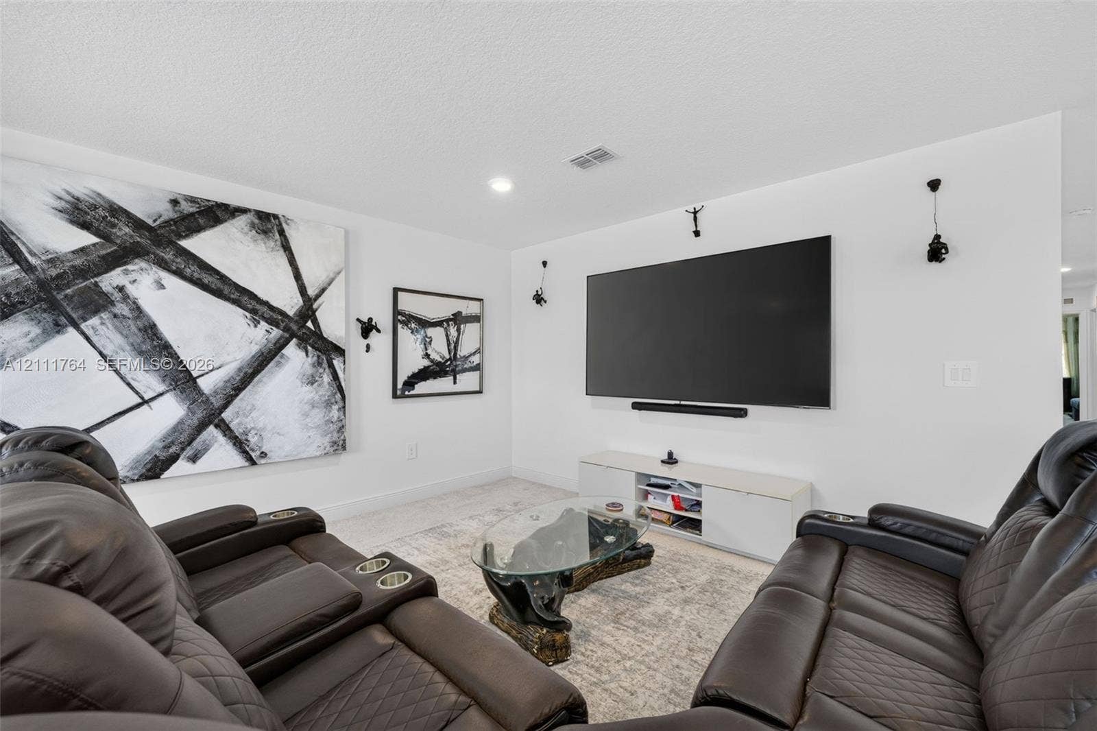 Interior space featuring neutral wall tones, recessed lighting, and wall-mounted light fixtures