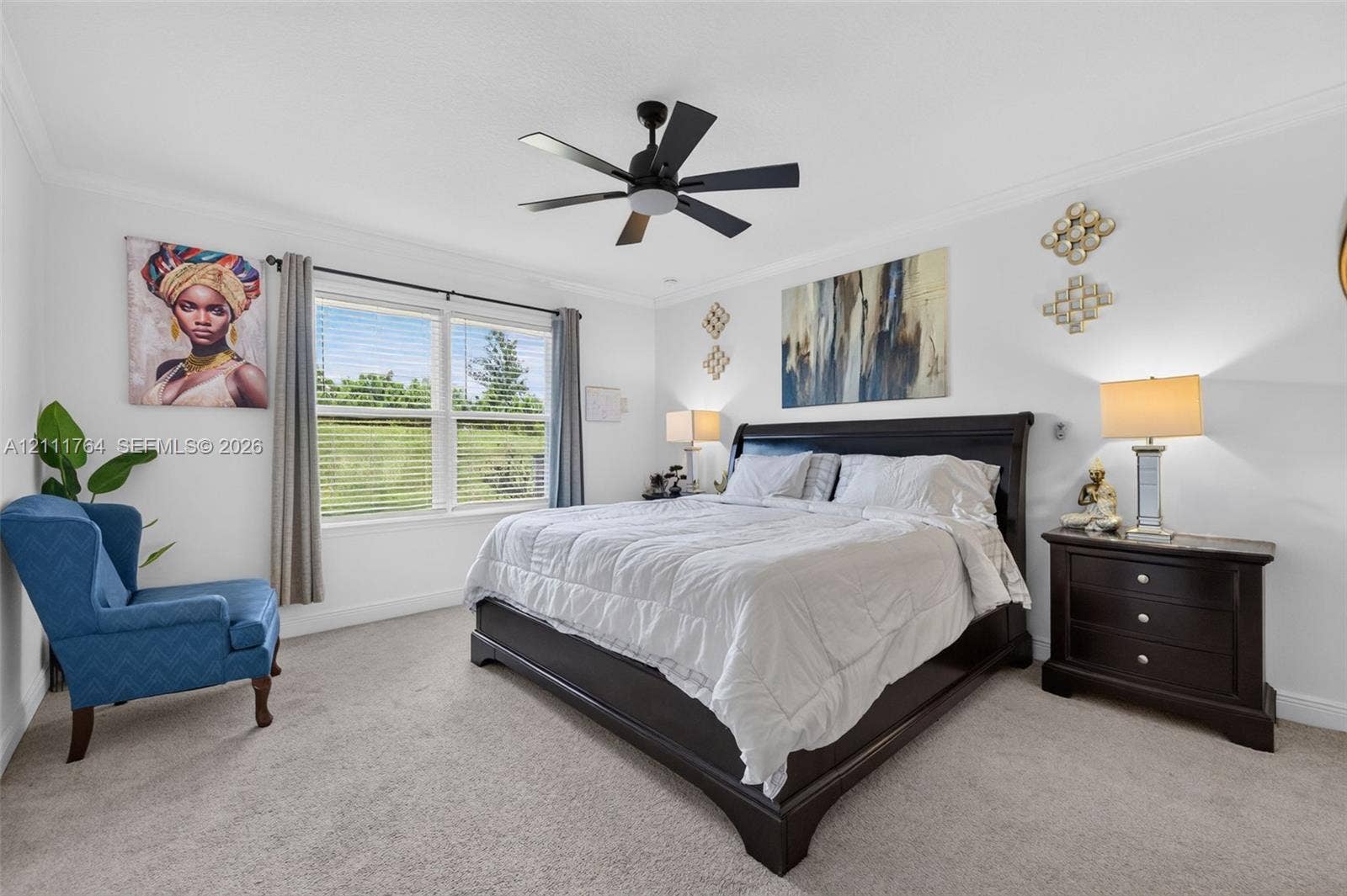 Bedroom featuring neutral wall-to-wall carpeting, crown molding, multi-blade ceiling fan, and large windows with horizontal blinds