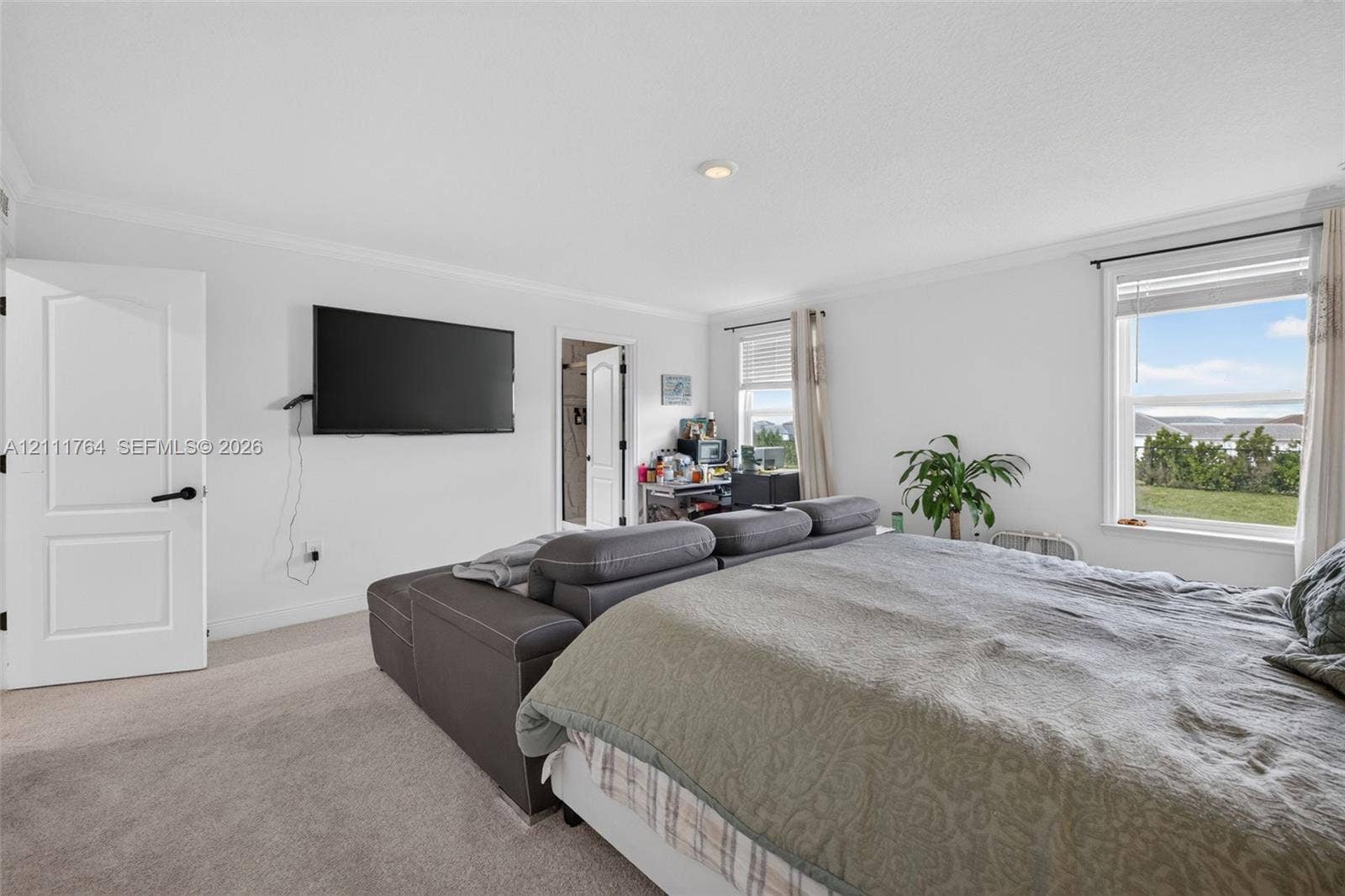 Neutral wall coloring, carpeted flooring, recessed lighting, and multiple windows with exterior exposure