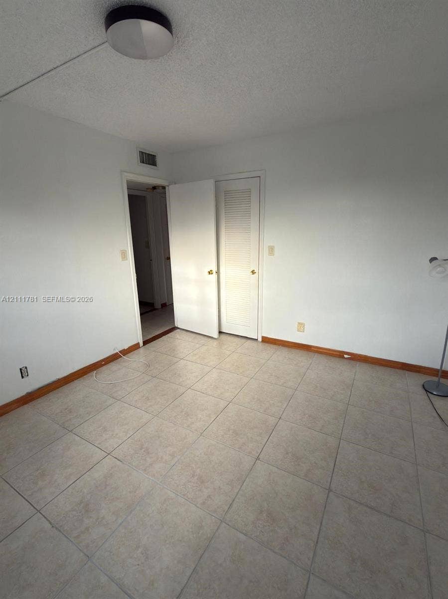 900 NE 12th Avenue, #401, Hallandale Beach, Hallandale Beach, FL 33009 Ceramic tile flooring, neutral wall finishes, and louvered closet door