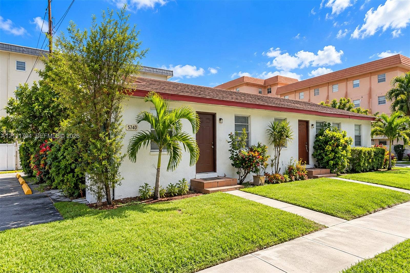 5740 NW 38th Street, #B, Virginia Gardens, Virginia Gardens, FL 33166 Single-story building exterior featuring a low-slope roof, stucco facade, two separate entry doors, and mature landscaping