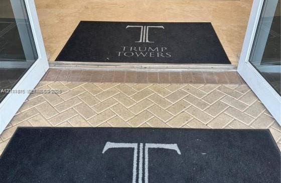 15811 Collins Avenue, #4102, Sunny Isles Beach, FL 33160 Entryway featuring glass-paneled double doors and herringbone-patterned stone paver flooring
