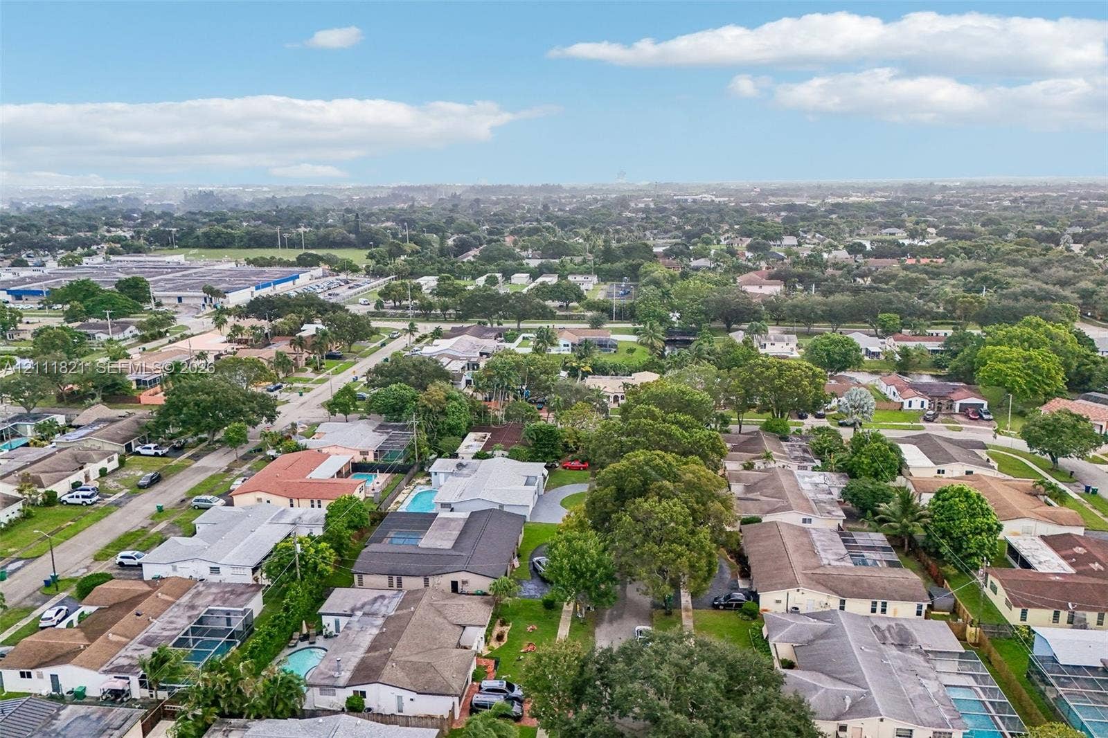 Aerial perspective of the residential parcel featuring dense mature canopy trees and a private swimming pool