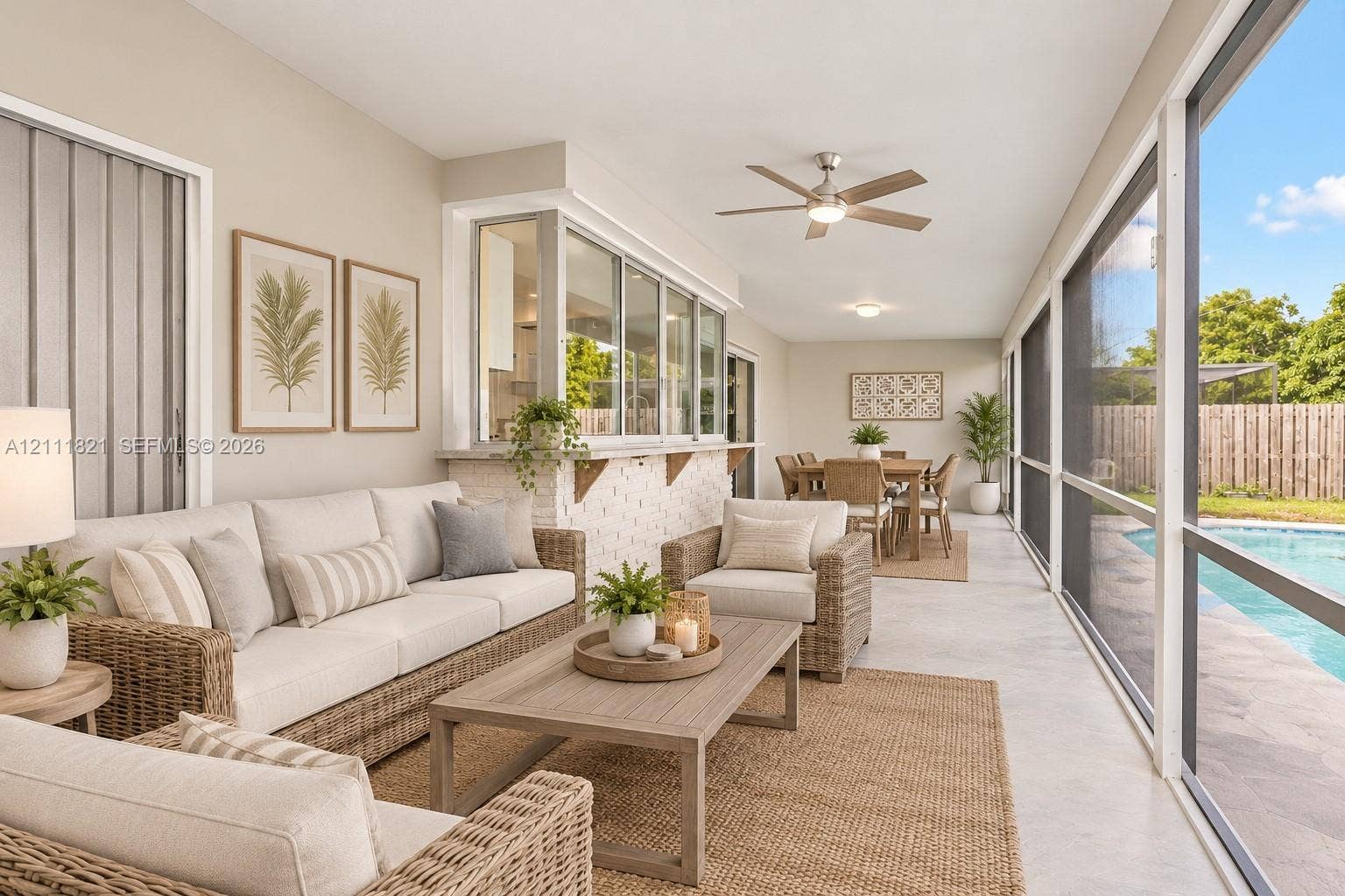 virtually staged screened-in patio featuring a service window direct access to an in-ground swimming pool