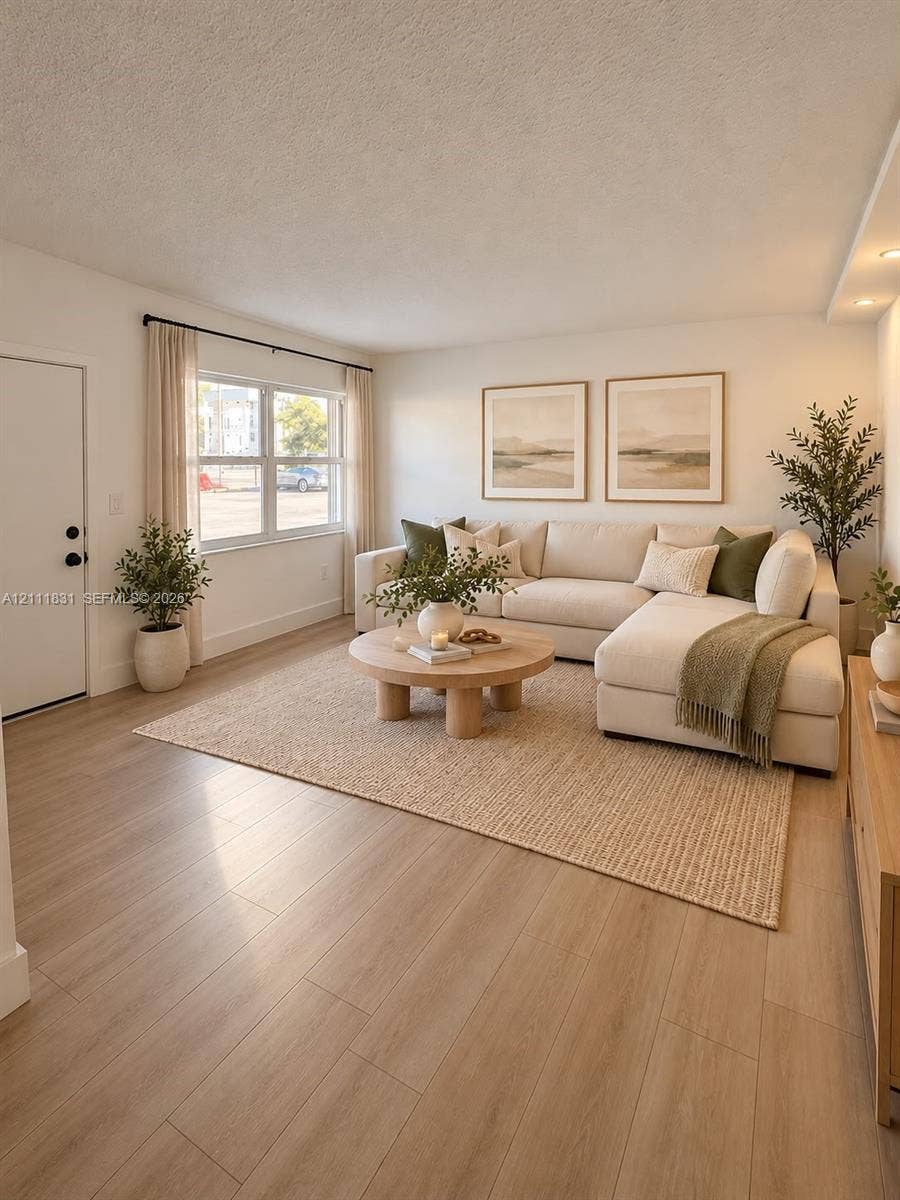 1629 N River Drive, #103, Miami, FL 33125 Living area featuring light-toned wood-finish flooring, dual-pane windows, and recessed lighting