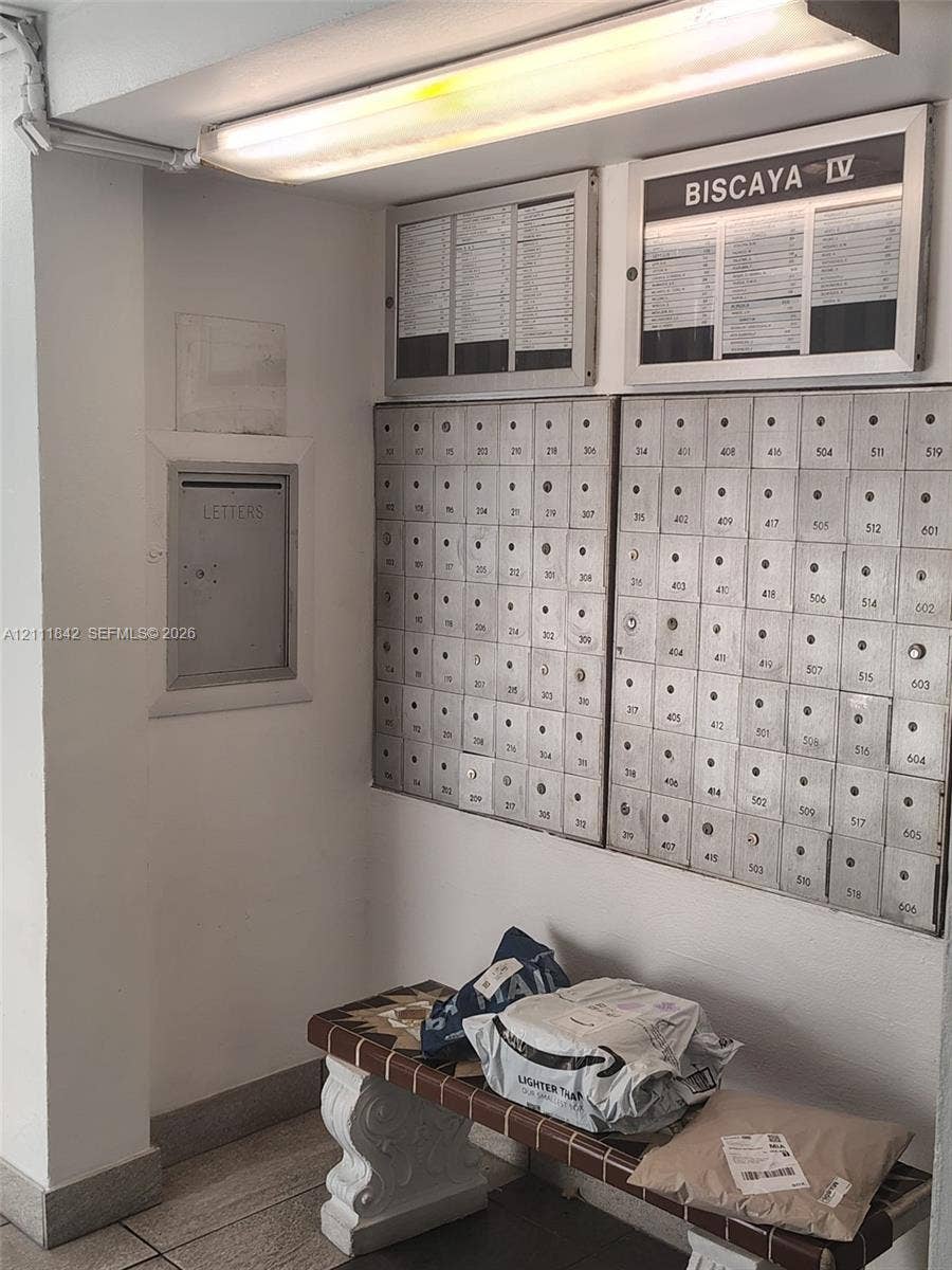 20400 W Country Club Drive, #303, Aventura, Aventura, FL 33180 Secured metal mail distribution center featuring a built-in mail slot and overhead fluorescent lighting