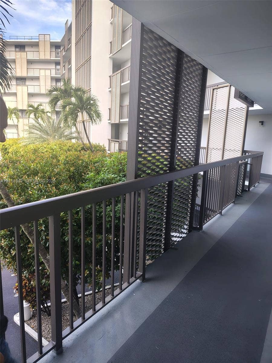 20400 W Country Club Drive, #303, Aventura, Aventura, FL 33180 Covered exterior walkway featuring a metal railing and decorative perforated privacy screening