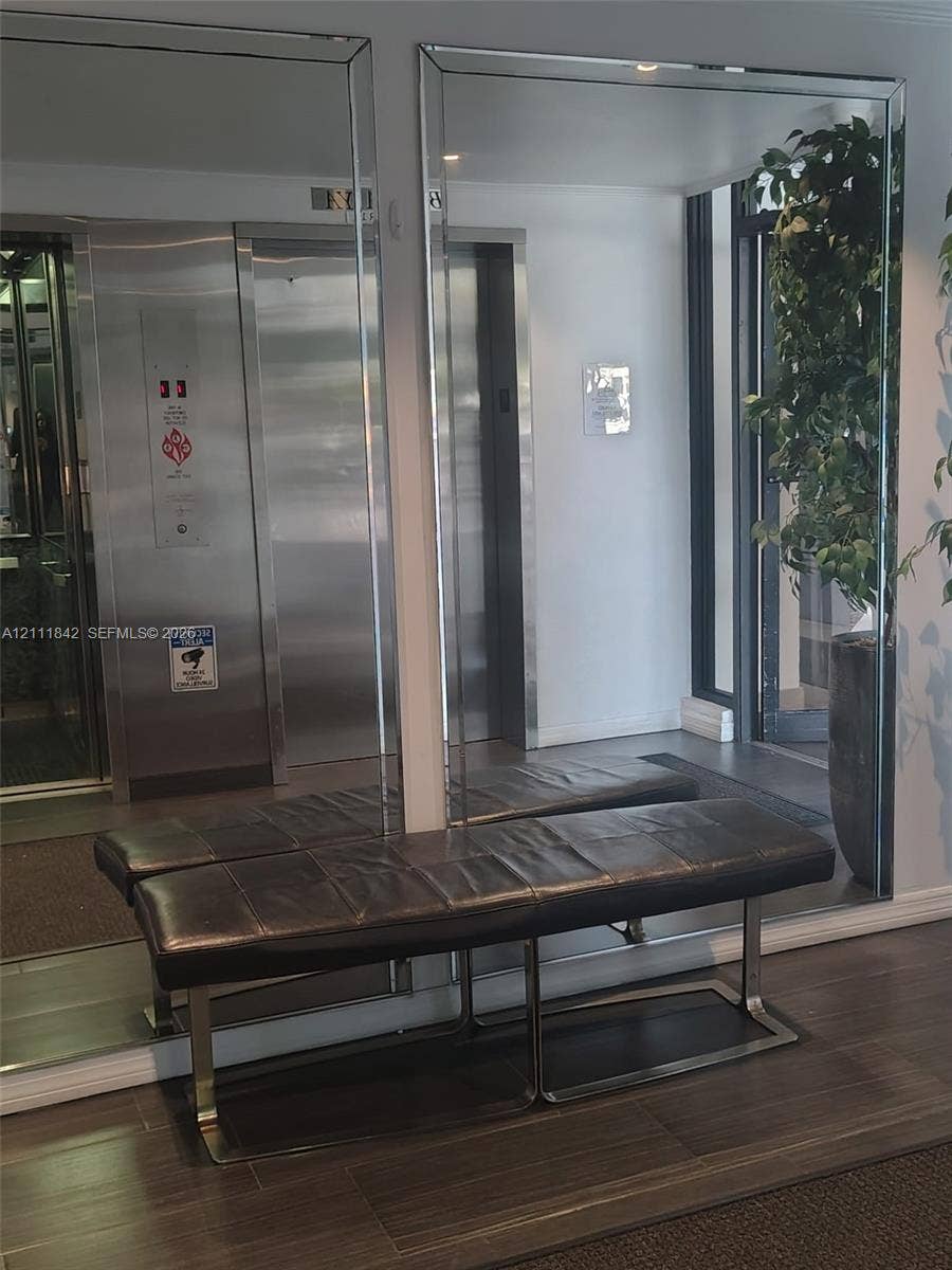 20400 W Country Club Drive, #303, Aventura, Aventura, FL 33180 Full-height wall mirrors, stainless steel elevator doors, and wood-finish flooring