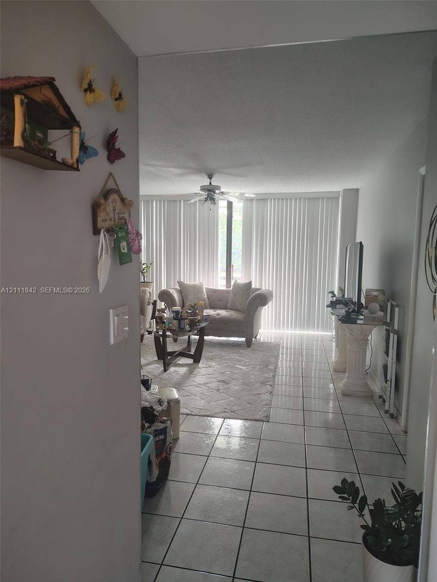 20400 W Country Club Drive, #303, Aventura, Aventura, FL 33180 Interior space featuring tile flooring, ceiling fan, and floor-to-ceiling vertical blinds