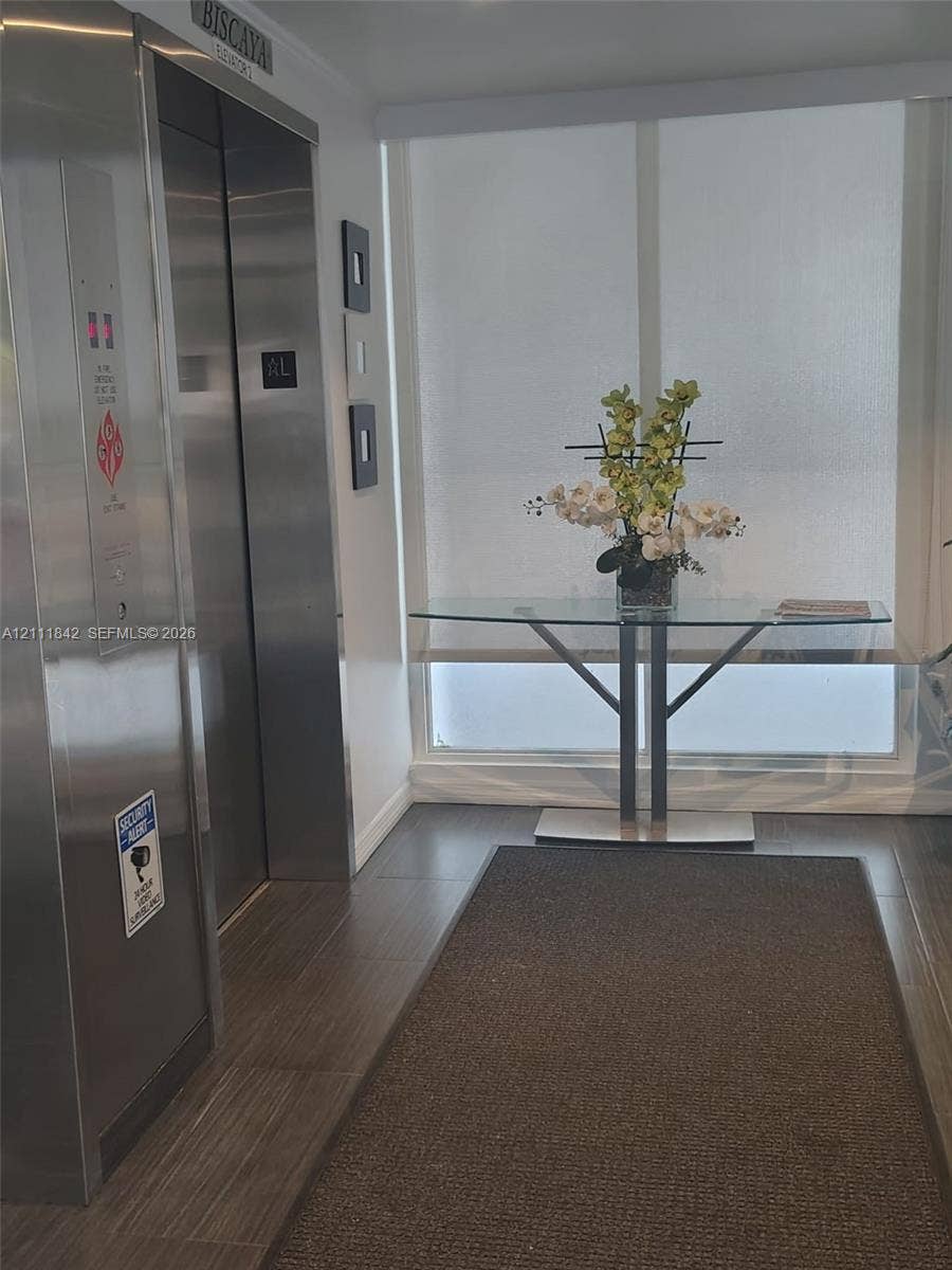 20400 W Country Club Drive, #303, Aventura, Aventura, FL 33180 Stainless steel elevator with digital interface, floor-to-ceiling windows with integrated roller shades, and large-format tile flooring