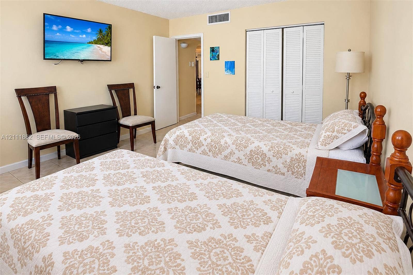 2030 S Ocean Drive, #2004, Hallandale Beach, FL 33009 Neutral wall tones, neutral tile flooring, and sliding louvered closet doors