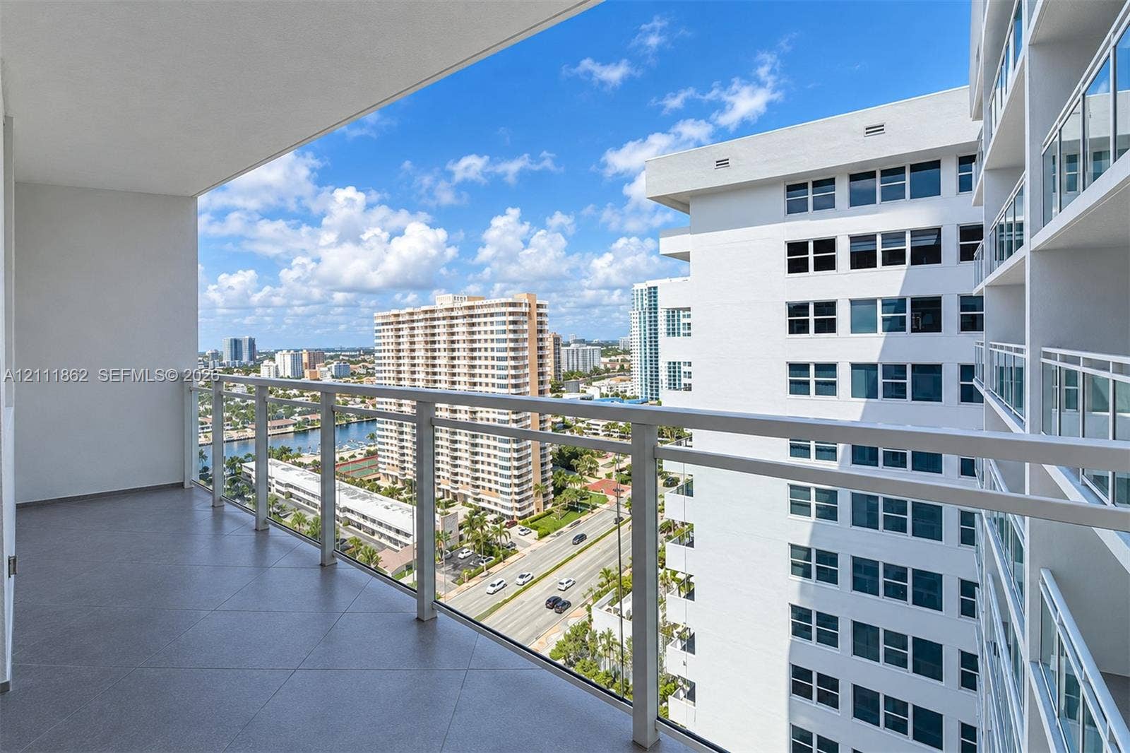 2030 S Ocean Drive, #2004, Hallandale Beach, FL 33009 Covered balcony featuring tile flooring and a glass-paneled railing