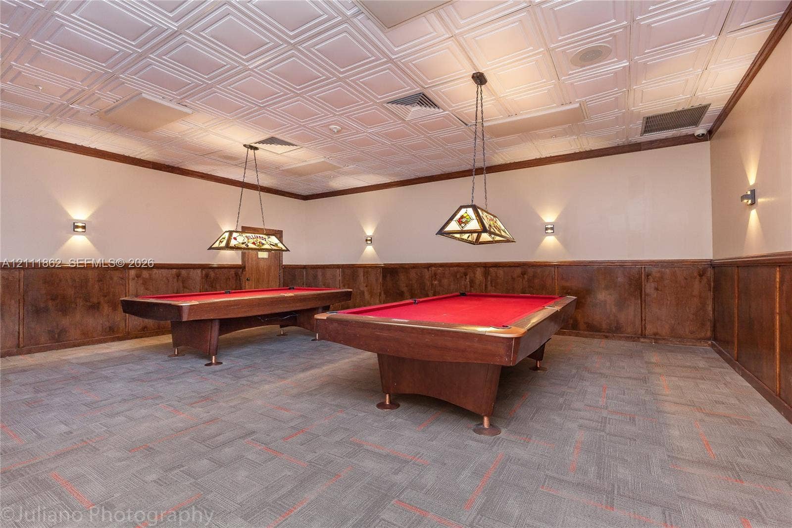 2030 S Ocean Drive, #2004, Hallandale Beach, FL 33009 Coffered ceiling tiles, stained wood wainscoting, and decorative stained-glass pendant lighting