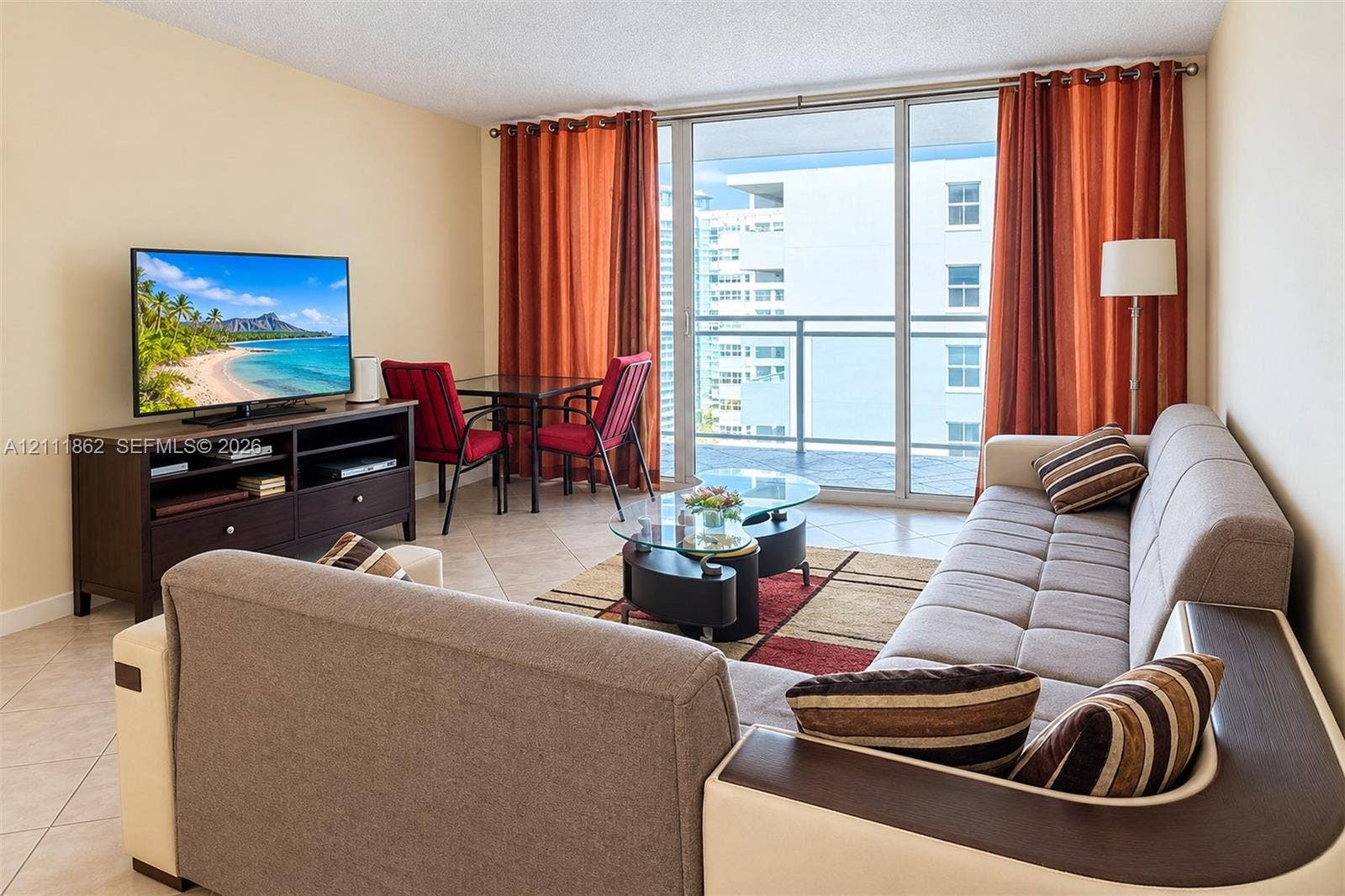 2030 S Ocean Drive, #2004, Hallandale Beach, FL 33009 Living space featuring large-format ceramic tile flooring, floor-to-ceiling glass sliding doors, and a private balcony with metal railing