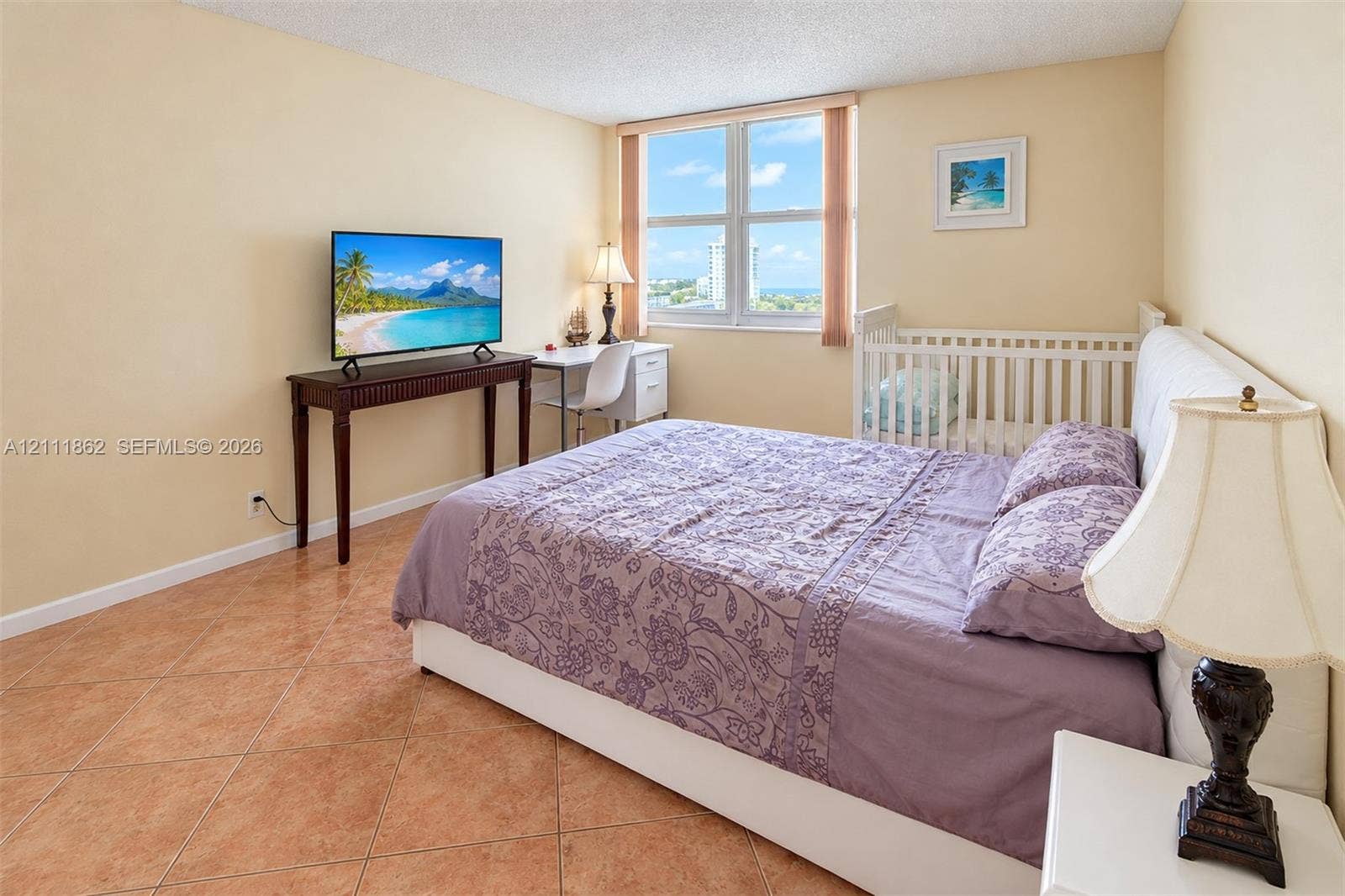 2030 S Ocean Drive, #2004, Hallandale Beach, FL 33009 Large window with exterior coastal scenery, tile flooring, and textured ceiling finish