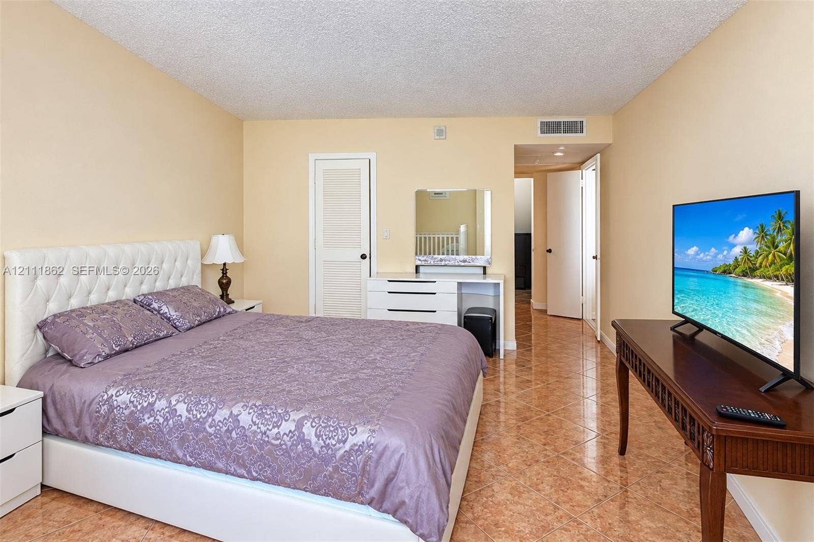 2030 S Ocean Drive, #2004, Hallandale Beach, FL 33009 Room featuring polished tile flooring, neutral wall tones, and a built-in louvered-door closet