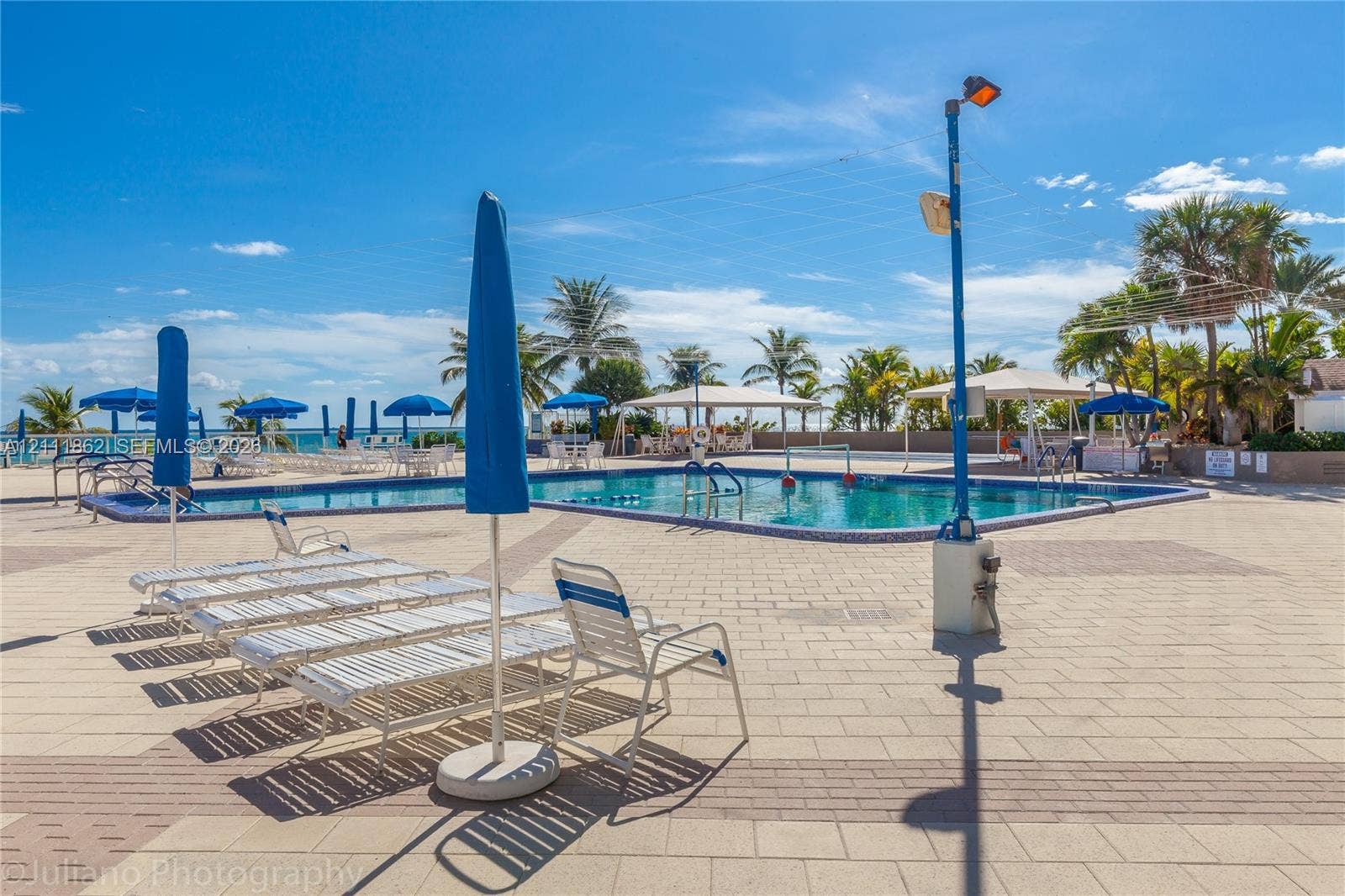 2030 S Ocean Drive, #2004, Hallandale Beach, FL 33009 Outdoor swimming pool with tile surround, paved decking, and covered patio structures