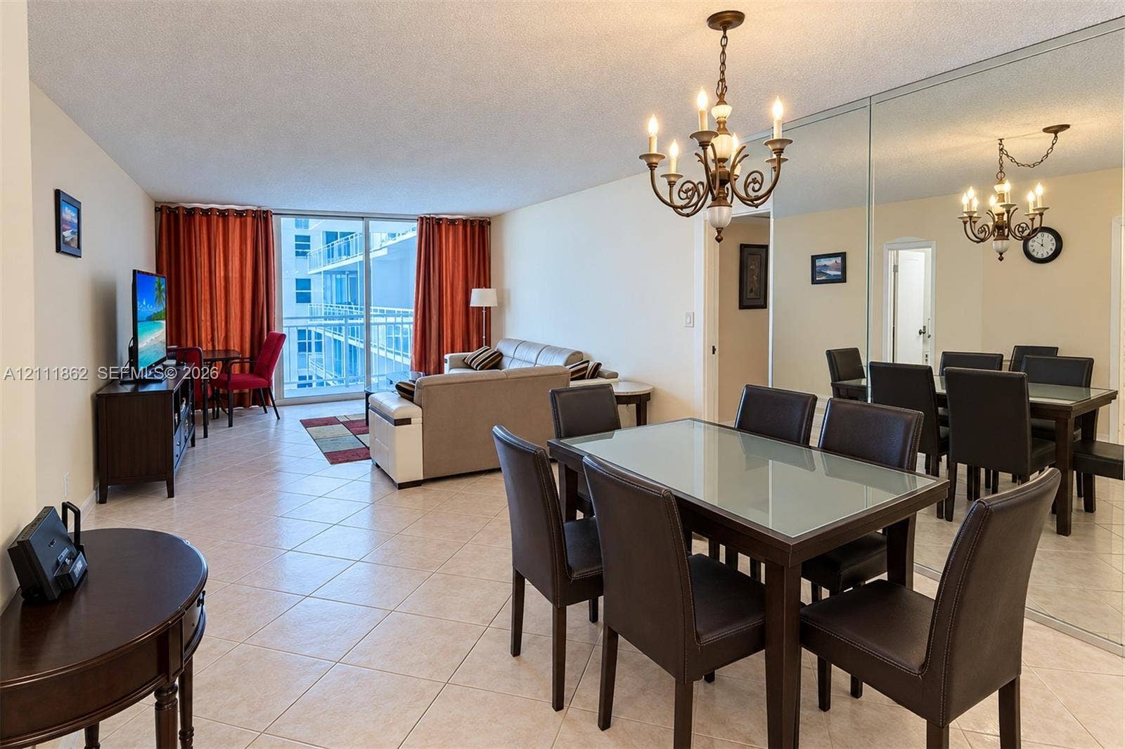 2030 S Ocean Drive, #2004, Hallandale Beach, FL 33009 Open-concept floor plan featuring tile flooring, a floor-to-ceiling mirrored wall, iron-style chandelier, and glass balcony door
