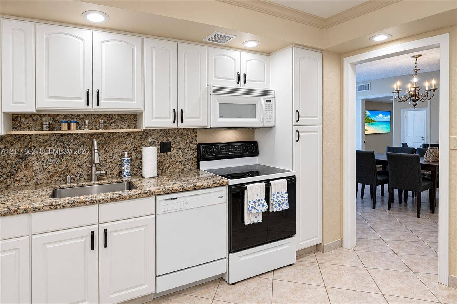 2030 S Ocean Drive, #2004, Hallandale Beach, FL 33009 Kitchen featuring white shaker-style cabinetry, stone-finish countertops, stainless steel undermount sink, built-in microwave, and recessed lighting