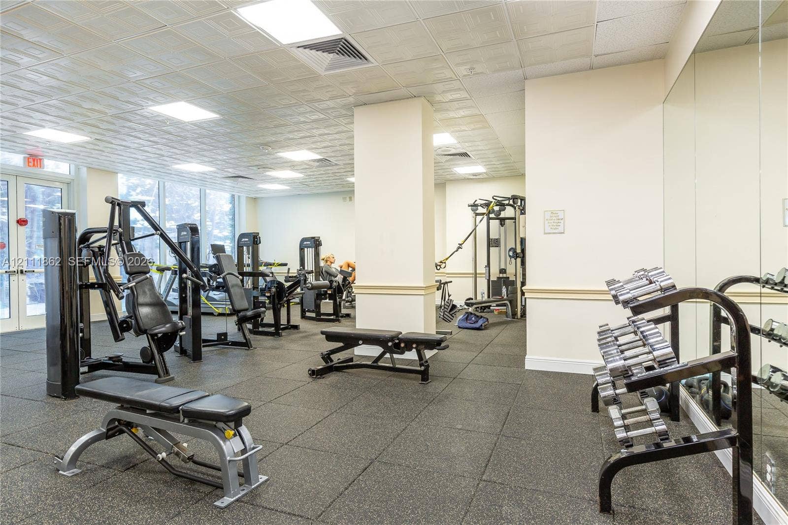 2030 S Ocean Drive, #2004, Hallandale Beach, FL 33009 Fitness center featuring rubber flooring, floor-to-ceiling mirrored walls, recessed ceiling lighting, and expansive glass paneled doors
