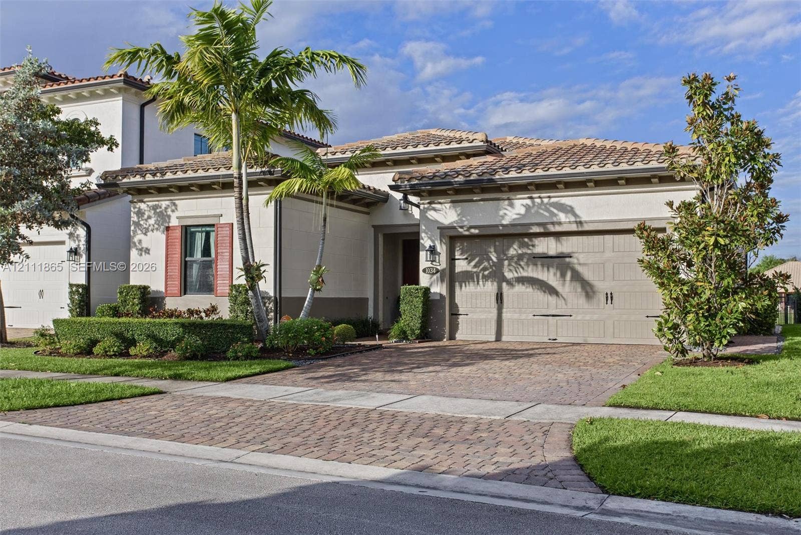 1034 SW 113th Avenue, Pembroke Pines, FL 33025 Mediterranean-style exterior featuring tiled roof & decorative shutters.