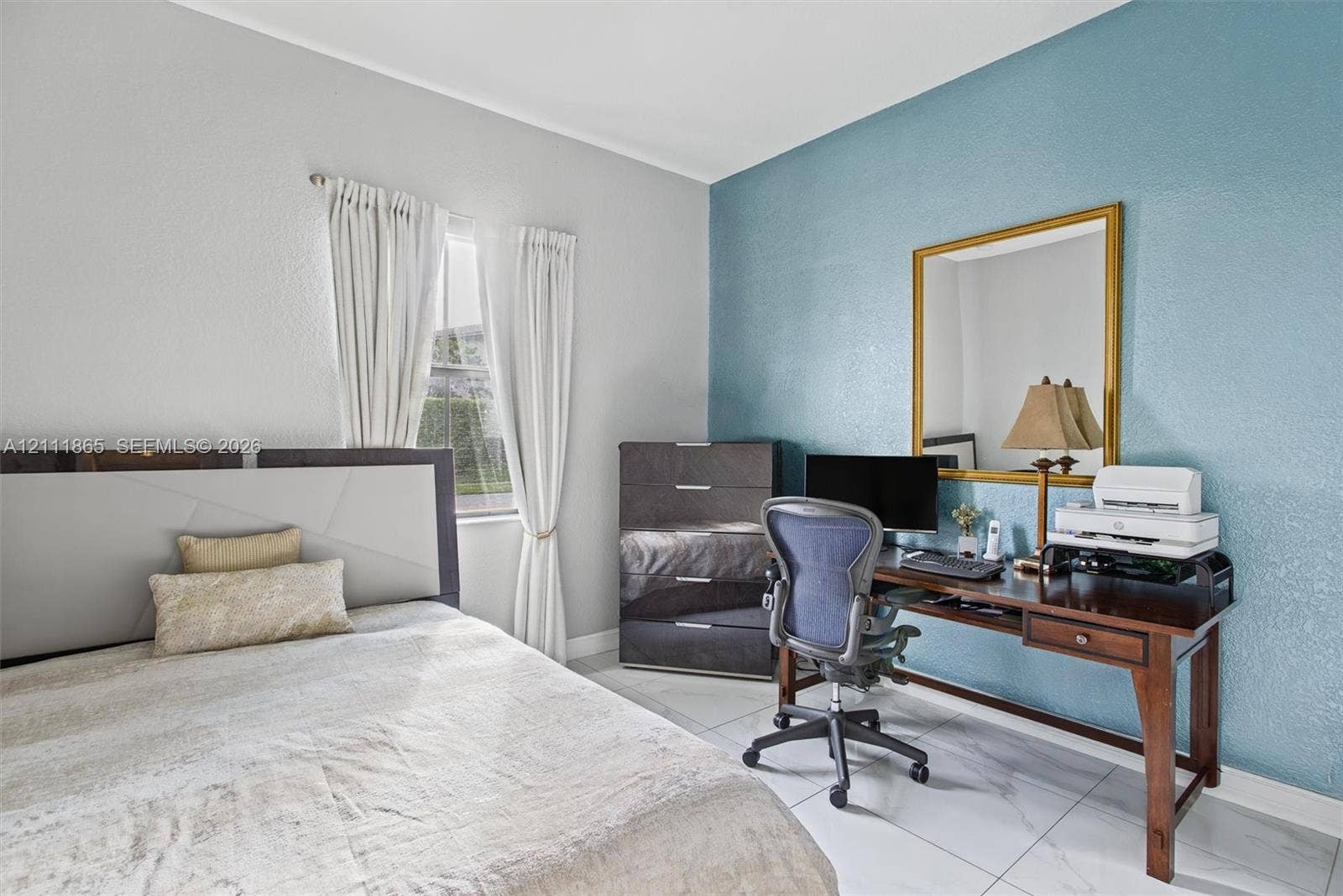 1034 SW 113th Avenue, Pembroke Pines, FL 33025 Second Bedroom featuring large-format tile flooring, single-pane window, and an accent wall