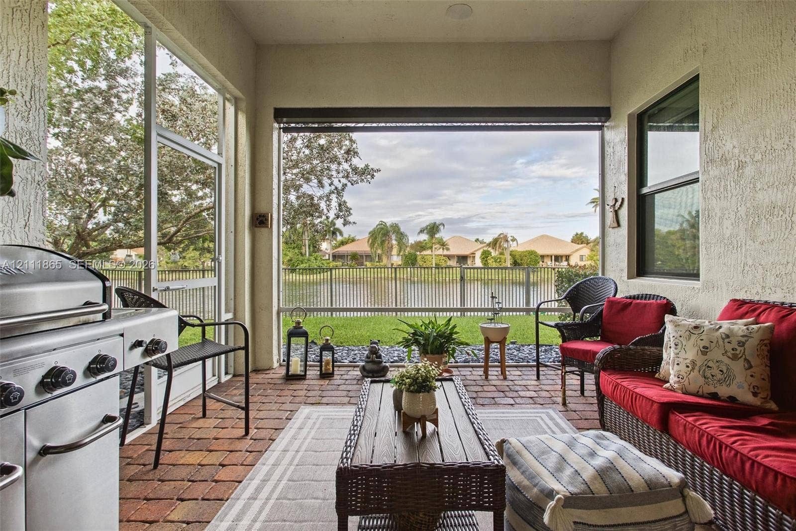 1034 SW 113th Avenue, Pembroke Pines, FL 33025 Cozy screened-in lanai with additional sunscreen & great water view.