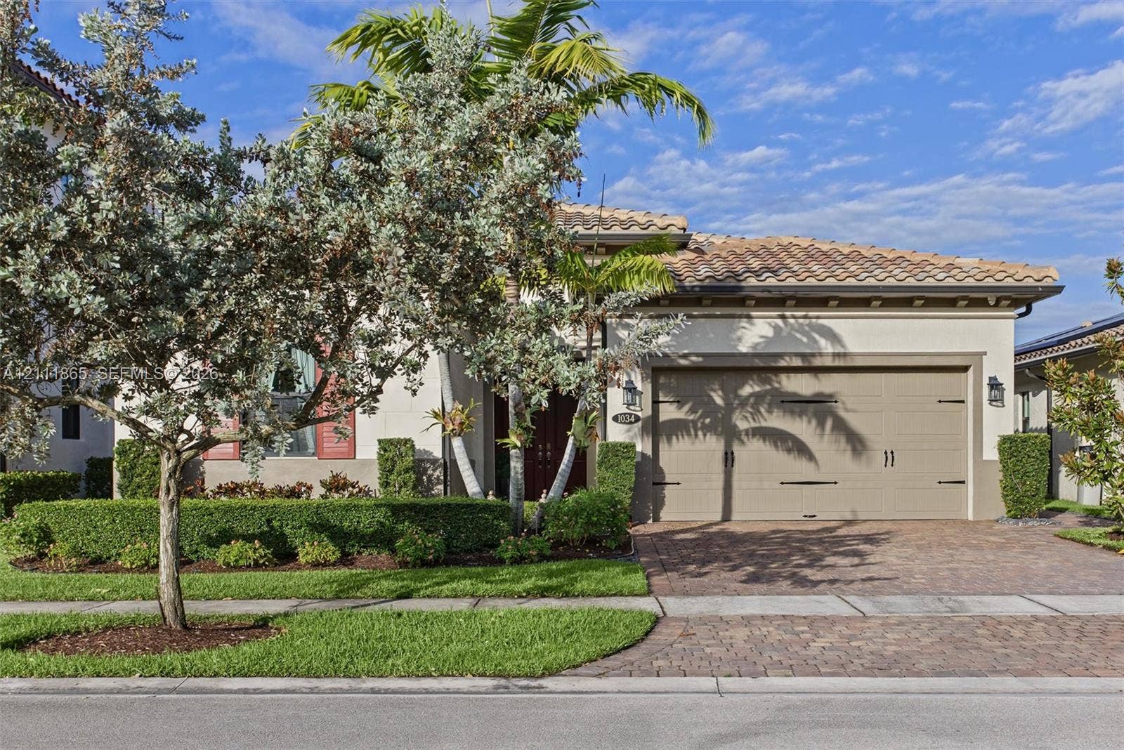 1034 SW 113th Avenue, Pembroke Pines, FL 33025 Delightful exterior featuring manicured landscape and tiled driveway.