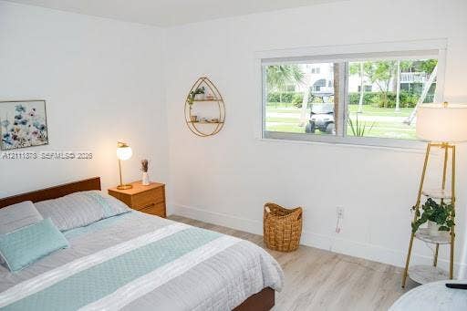 201 Galen Drive, #110, Key Biscayne, FL 33149 Neutral-toned interior featuring wood-finish flooring and a wide, horizontal sliding window
