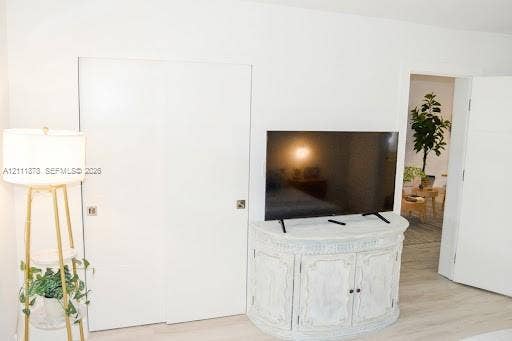 201 Galen Drive, #110, Key Biscayne, FL 33149 Interior space featuring wood-finish flooring and floor-to-ceiling closet with flush-mount square hardware