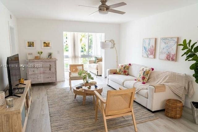 201 Galen Drive, #110, Key Biscayne, FL 33149 Living area featuring neutral wall paint, wood-finish flooring, and a ceiling-mounted fan with integrated lighting