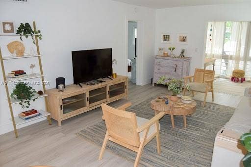201 Galen Drive, #110, Key Biscayne, FL 33149 Light-toned wood-finish flooring, smooth wall surfaces, and sliding glass panel doors