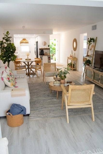 201 Galen Drive, #110, Key Biscayne, FL 33149 Open-concept interior featuring wood-finish flooring, neutral walls, and a recessed ceiling lighting fixture