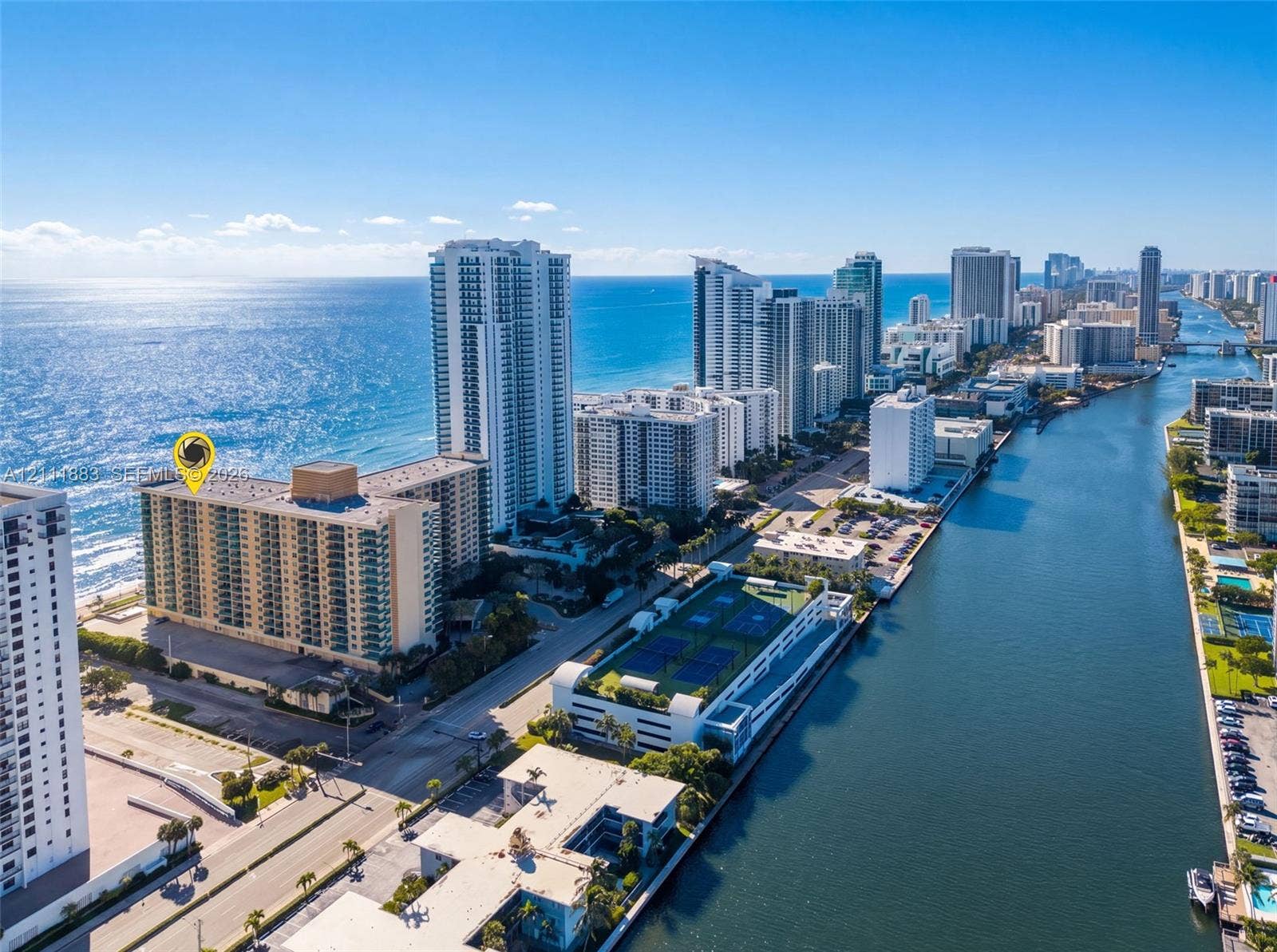 High-rise residential building featuring expansive oceanfront positioning, balcony access, and proximity to coastal waterways