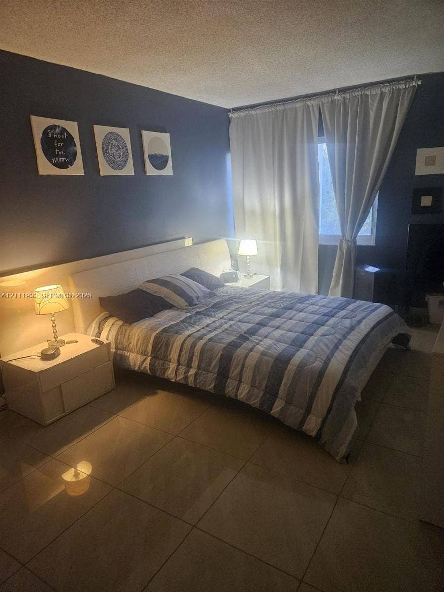 711 N Pine Island Road, #402, Plantation, Plantation, FL 33324 Room featuring large-format tile flooring and a window with floor-to-ceiling drapery