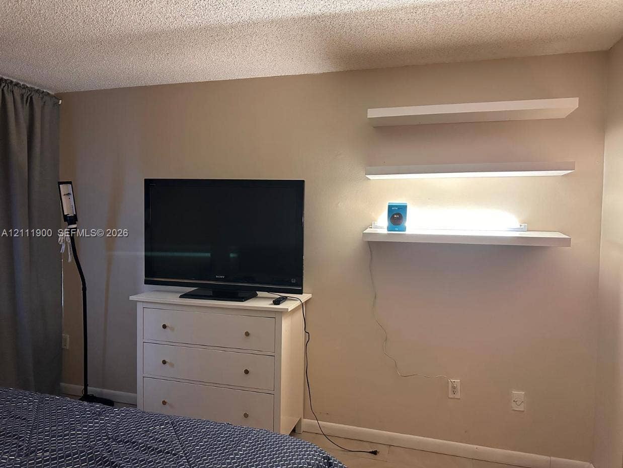 711 N Pine Island Road, #402, Plantation, Plantation, FL 33324 Wall-mounted white floating shelving featuring integrated lighting