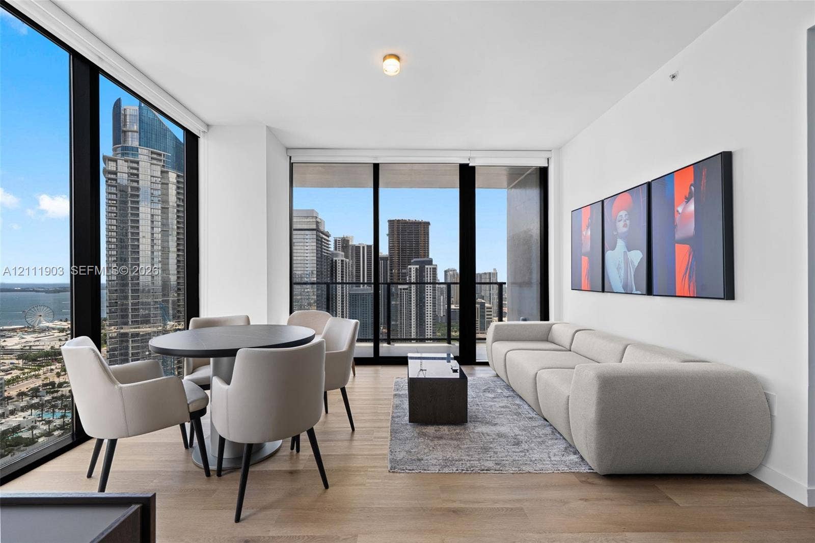 20 NE 11th Street, #4308, Miami, FL 33132 Floor-to-ceiling glass windows, wide-plank wood-finish flooring, and an integrated balcony with metal railing