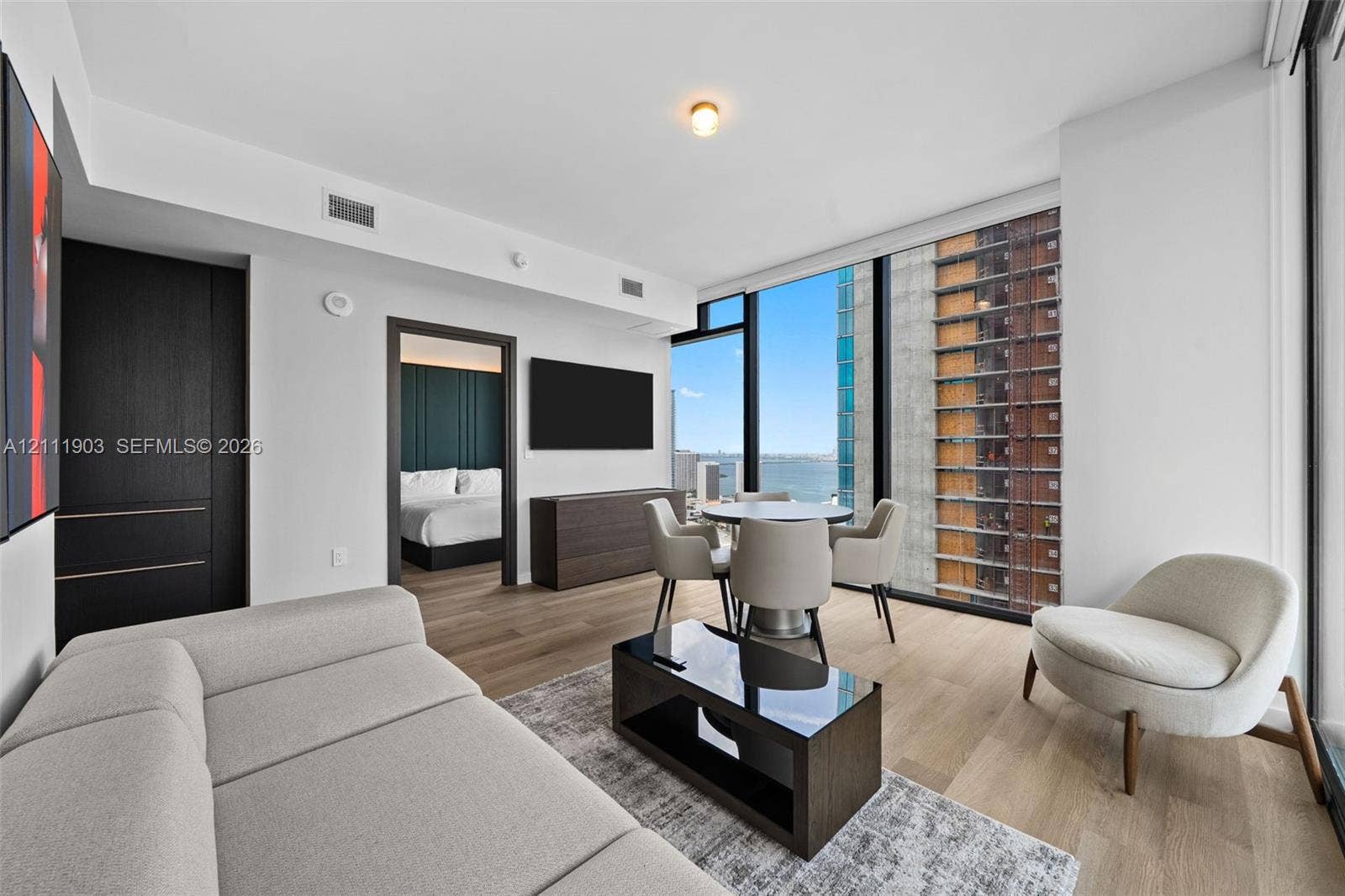 20 NE 11th Street, #4308, Miami, FL 33132 Floor-to-ceiling windows, wood-finish flooring, and dark-toned built-in cabinetry