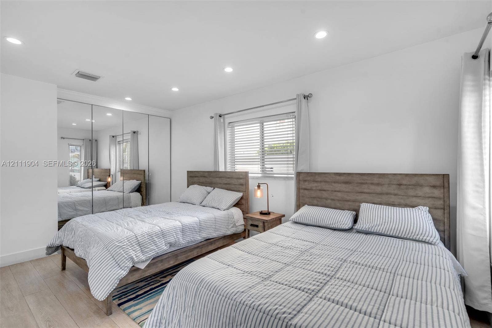 821 Harrison Street, Hollywood, FL 33019 Bedroom featuring wood-finish flooring, recessed lighting, and mirrored sliding-door closet